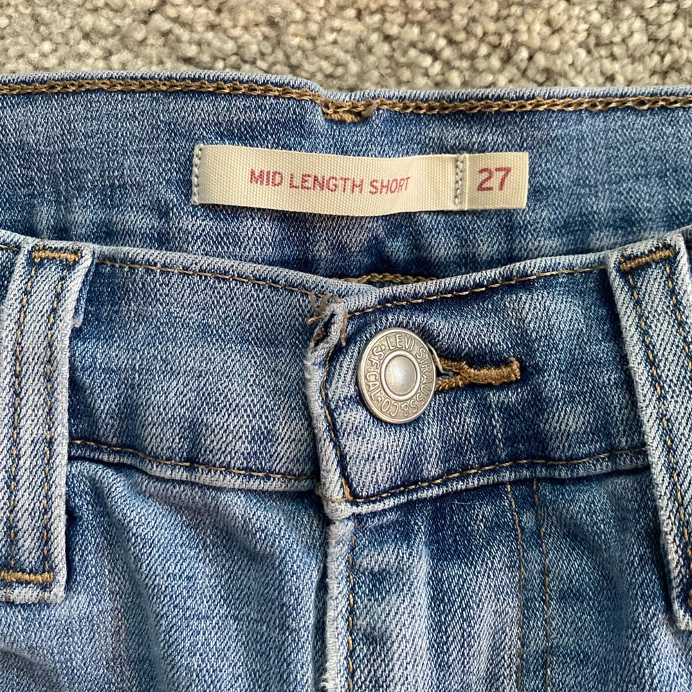 Levi mid length high waisted slightly ripped jean shorts